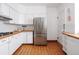 Modern kitchen with white cabinets, stainless steel appliances, and terracotta tile floors at 836 E 17Th Ave # 2E, Denver, CO 80218