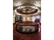 Circular landing with wood railings, stained glass, and elegant staircase at 836 E 17Th Ave # 2E, Denver, CO 80218