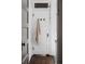 Hallway with white door, brass hooks, and light colored towel at 836 E 17Th Ave # 2E, Denver, CO 80218