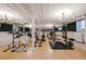 Spacious gym with hardwood floors, exercise equipment, and unique architectural details at 836 E 17Th Ave # 2E, Denver, CO 80218