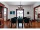 Elegant dining room with a chandelier, hardwood floors, and a dark wood hutch at 836 E 17Th Ave # 2E, Denver, CO 80218