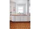 Bright kitchen with white cabinets, wood countertops, and terracotta tile floor at 836 E 17Th Ave # 2E, Denver, CO 80218