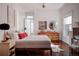 Spacious bedroom with hardwood floors, a dresser, and large windows at 836 E 17Th Ave # 2E, Denver, CO 80218