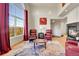 Bright living room featuring a fireplace and large windows with scenic views at 11770 Leavenworth Dr, Conifer, CO 80433