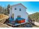 Two-story house with deck, hot tub, mountain views, and wood siding at 11770 Leavenworth Dr, Conifer, CO 80433