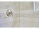 Close-up of a shower with marble tile and modern fixtures at 11770 Leavenworth Dr, Conifer, CO 80433