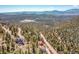 Aerial view showing home's location in wooded mountain neighborhood at 11770 Leavenworth Dr, Conifer, CO 80433