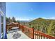 Deck overlooking scenic mountain views and lush greenery at 11770 Leavenworth Dr, Conifer, CO 80433