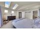 Main bedroom with skylights and ensuite bathroom at 11770 Leavenworth Dr, Conifer, CO 80433