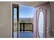 Open door reveals mountain views from entryway at 11770 Leavenworth Dr, Conifer, CO 80433