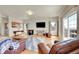 Spacious living room with wood floors, wood burning stove, and access to deck at 11770 Leavenworth Dr, Conifer, CO 80433