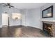 Living room with hardwood floors, fireplace, and kitchen view at 5775 W Atlantic Pl # 303, Lakewood, CO 80227