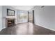 Living room with fireplace, hardwood floors, and sliding door to balcony at 5775 W Atlantic Pl # 303, Lakewood, CO 80227