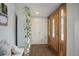 Bright entryway with hardwood floors, coat bench, and wooden door at 6867 S Elizabeth St, Centennial, CO 80122