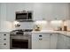 Stainless steel appliances and white cabinets in this updated kitchen at 6867 S Elizabeth St, Centennial, CO 80122