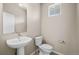 Clean and modern bathroom with pedestal sink and toilet at 21239 E 62Nd Ave, Aurora, CO 80019