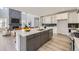 Modern kitchen with a large island, white cabinets, and stainless steel appliances at 11077 Star Fall St, Littleton, CO 80125