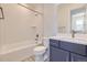 Modern bathroom with a tub, shower, and dark vanity at 11077 Star Fall St, Littleton, CO 80125