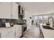 Modern kitchen with white cabinets, quartz countertops, and stainless steel appliances at 11077 Star Fall St, Littleton, CO 80125