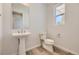 Simple and clean powder room with pedestal sink at 11077 Star Fall St, Littleton, CO 80125