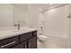 Clean and modern bathroom with a bathtub and dark vanity at 11077 Star Fall St, Littleton, CO 80125