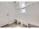 White mudroom with bench, cubbies, and hooks at 11077 Star Fall St, Littleton, CO 80125