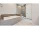 Spa-like bathroom with soaking tub and glass shower at 11077 Star Fall St, Littleton, CO 80125