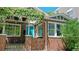 Brick home with a covered entryway and mature landscaping at 1137 Colorado Blvd, Denver, CO 80206