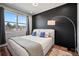 Bright bedroom featuring a comfy bed and a dark accent wall at 1025 S Gilbert St # C, Castle Rock, CO 80104