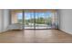 Bright living room with hardwood floors and sliding glass doors leading to a balcony at 3100 E Cherry Creek S Dr # 307, Denver, CO 80209