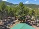 Aerial view of property showing home, detached structures and surrounding mountain landscape at 28 Deer Rd, Evergreen, CO 80439