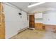 Workshop with concrete floor, shelving, and a door to outside at 28 Deer Rd, Evergreen, CO 80439