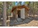 Wooden shed with a ramp and a white door at 28 Deer Rd, Evergreen, CO 80439