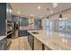 Modern kitchen with blue cabinets, large island, and stainless steel appliances at 6220 Waterman Way, Frederick, CO 80516