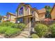 Tan two-story townhome with landscaping and steps at 1736 S Pagosa Way, Aurora, CO 80017