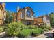 Tan two-story townhome with landscaping and walkway at 1736 S Pagosa Way, Aurora, CO 80017