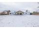 Expansive backyard view showcasing the house and snow-covered ground at 3660 Betty St, Castle Rock, CO 80108