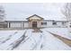 White two-story house with attached two-car garage and snow-covered driveway at 3660 Betty St, Castle Rock, CO 80108