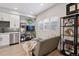Modern kitchen with white cabinets, stainless steel appliances, and gray backsplash at 2466 S Delaware St # 2, Denver, CO 80223
