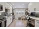 Modern kitchen features white cabinets, stainless steel appliances, and a breakfast bar at 2466 S Delaware St # 2, Denver, CO 80223