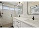 Modern bathroom with hexagon tile shower, double vanity, and matte black fixtures at 2466 S Delaware St # 2, Denver, CO 80223