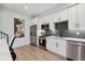 Modern kitchen with white cabinets and stainless steel appliances at 2466 S Delaware St # 2, Denver, CO 80223