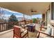 Covered deck with fire pit and comfortable seating area at 22580 E Ridge Trail Dr, Aurora, CO 80016