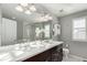 Modern bathroom with double vanity and a large walk-in shower at 9084 E 37Th Ave, Denver, CO 80238