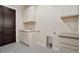 Convenient laundry room with cabinets, sink, and patterned flooring at 24113 E 36Th Pl, Aurora, CO 80019