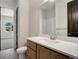 Bathroom with single vanity, toilet, and view to another bedroom at 24113 E 36Th Pl, Aurora, CO 80019