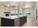 Modern kitchen with island, stainless steel appliances, and backyard access at 24113 E 36Th Pl, Aurora, CO 80019