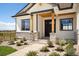 Front entrance of a modern farmhouse with stone accents and landscaping at 24113 E 36Th Pl, Aurora, CO 80019
