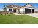 Modern farmhouse exterior with two-car garage and landscaped lawn at 24113 E 36Th Pl, Aurora, CO 80019