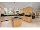 Large kitchen with light wood cabinets, black countertops, an island, and ample natural light at 1077 Carriage Hills Dr, Boulder, CO 80302